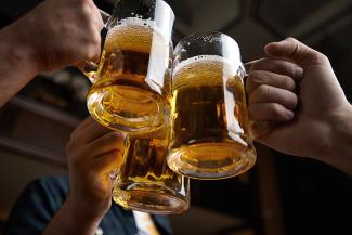 Beer mugs raised in a toast